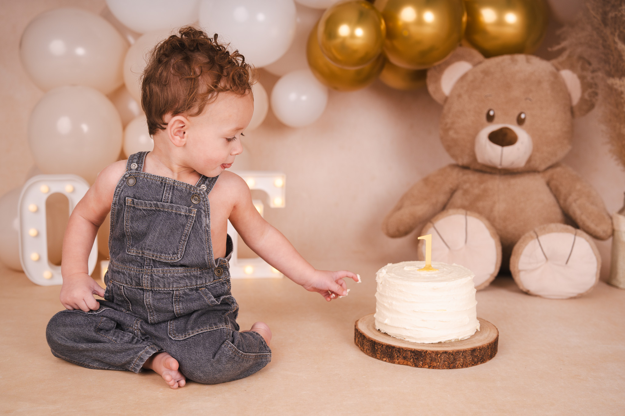 Baby in tuinbroek die zijn eerste verjaardag viert